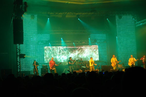 Large digital screens installed behind a live band